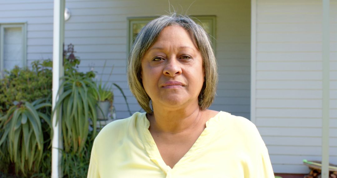 Middle-aged Woman Standing in Front of Suburban Home - Free Images, Stock Photos and Pictures on Pikwizard.com