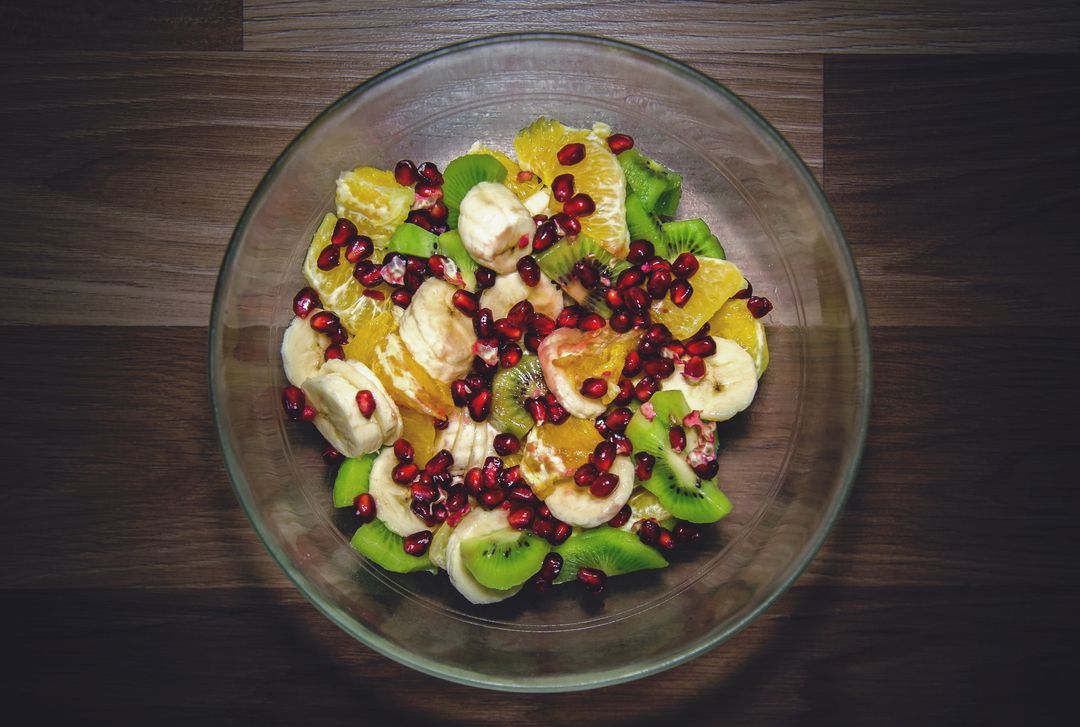 Colorful Fruit Salad Featuring Banana Slices, Kiwi Wedges, Orange Segments and Pomegranate
