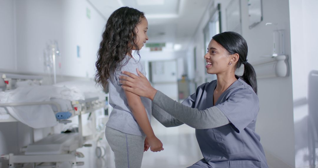 Nurse comforting child in hospital corridor - Free Images, Stock Photos and Pictures on Pikwizard.com