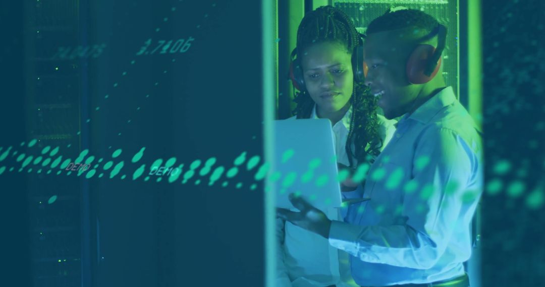 Diverse Professionals Analyzing Data in Server Room Environment