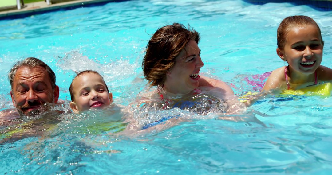 Joyful Family Relaxing Together in Swimming Pool - Free Images, Stock Photos and Pictures on Pikwizard.com