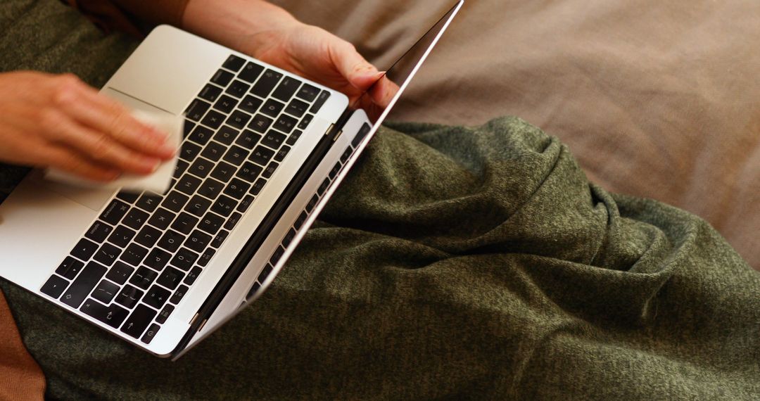 Person Using Laptop on Bed with Green Blanket - Free Images, Stock Photos and Pictures on Pikwizard.com