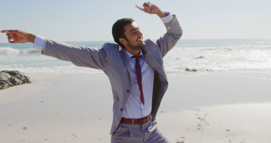 Businessman Celebrating on Beach in Suit and Tie - Free Images, Stock Photos and Pictures on Pikwizard.com