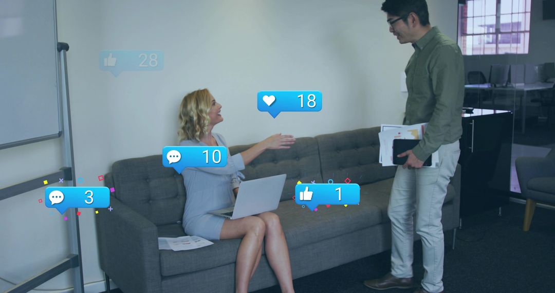Colleagues Discussing with Social Media Icons in Modern Office Lounge