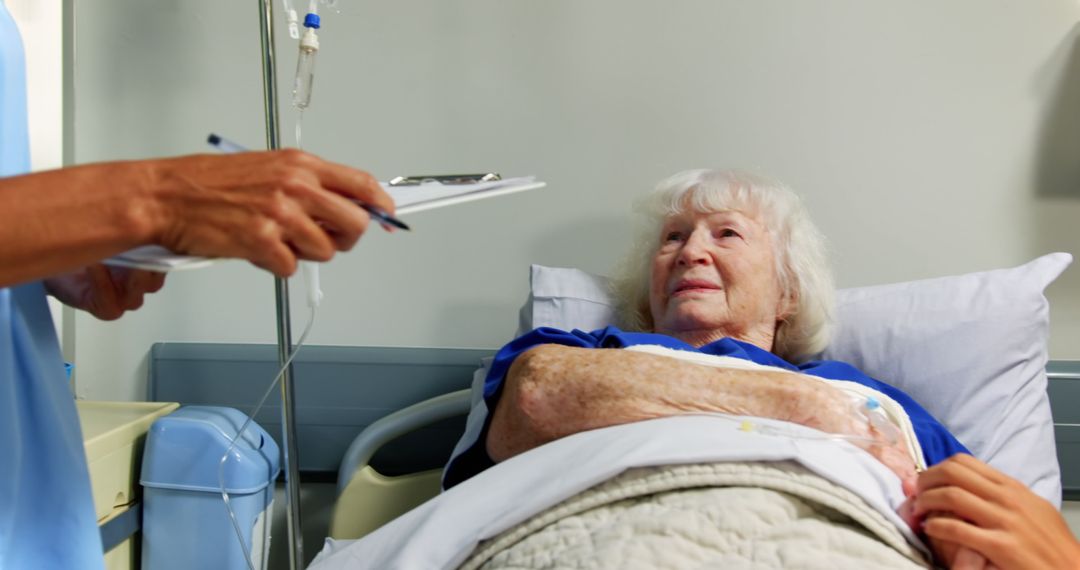 Nurse Checking on Elderly Patient in Hospital Bed - Free Images, Stock Photos and Pictures on Pikwizard.com