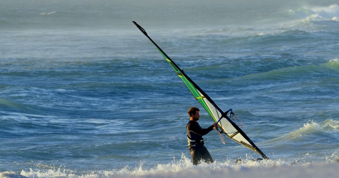 Man Wind Surfing at Beach on Sunny Day - Free Images, Stock Photos and Pictures on Pikwizard.com