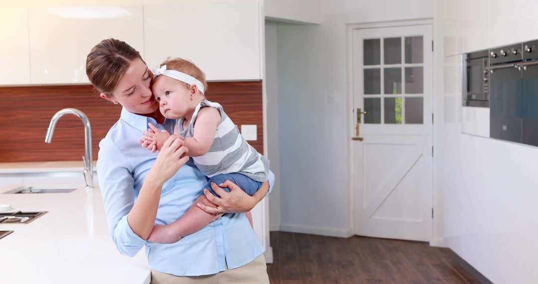 Mother Kissing Adorable Baby in Modern Kitchen Wearing Headband - Free Images, Stock Photos and Pictures on Pikwizard.com