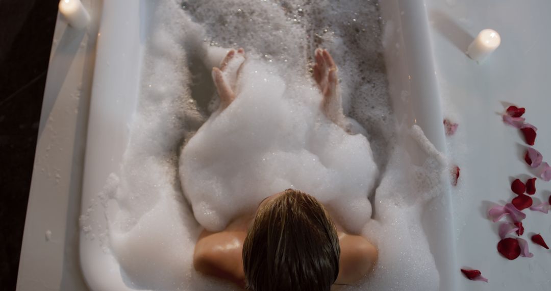 Woman Relaxing in Bubble Bath with Candles and Rose Petals - Free Images, Stock Photos and Pictures on Pikwizard.com