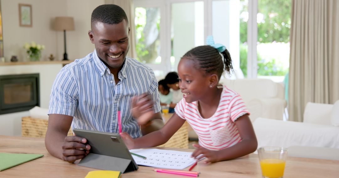 Father and Daughter Engaged in Homework with Tablet