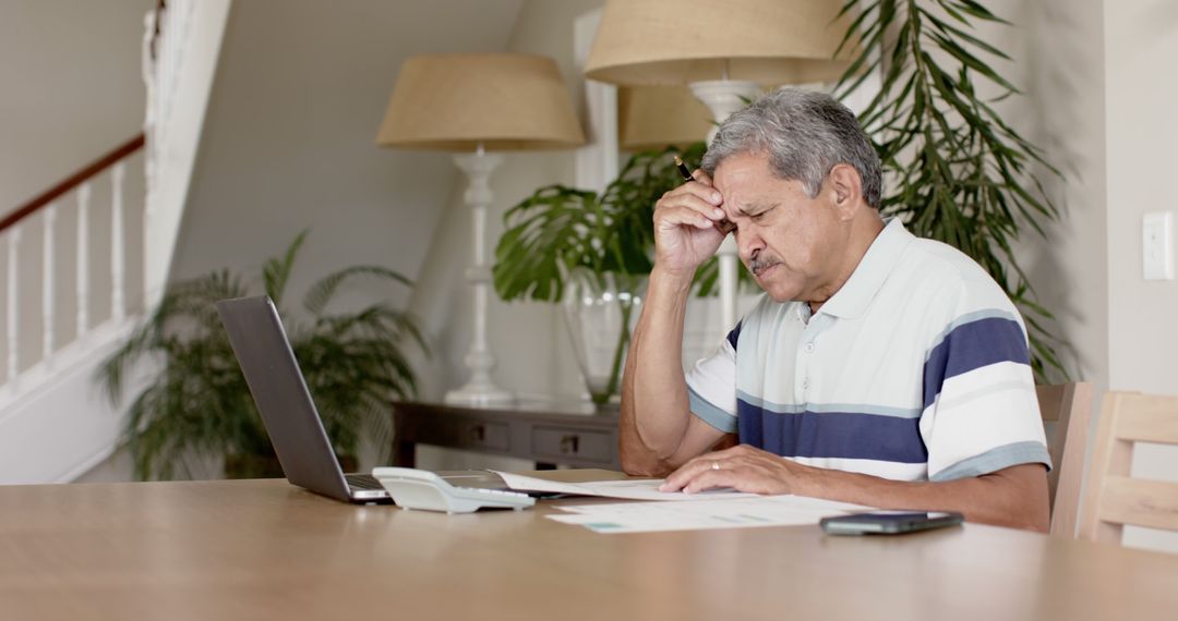 Senior Man Working from Home, Stressed with Financial Papers - Free Images, Stock Photos and Pictures on Pikwizard.com