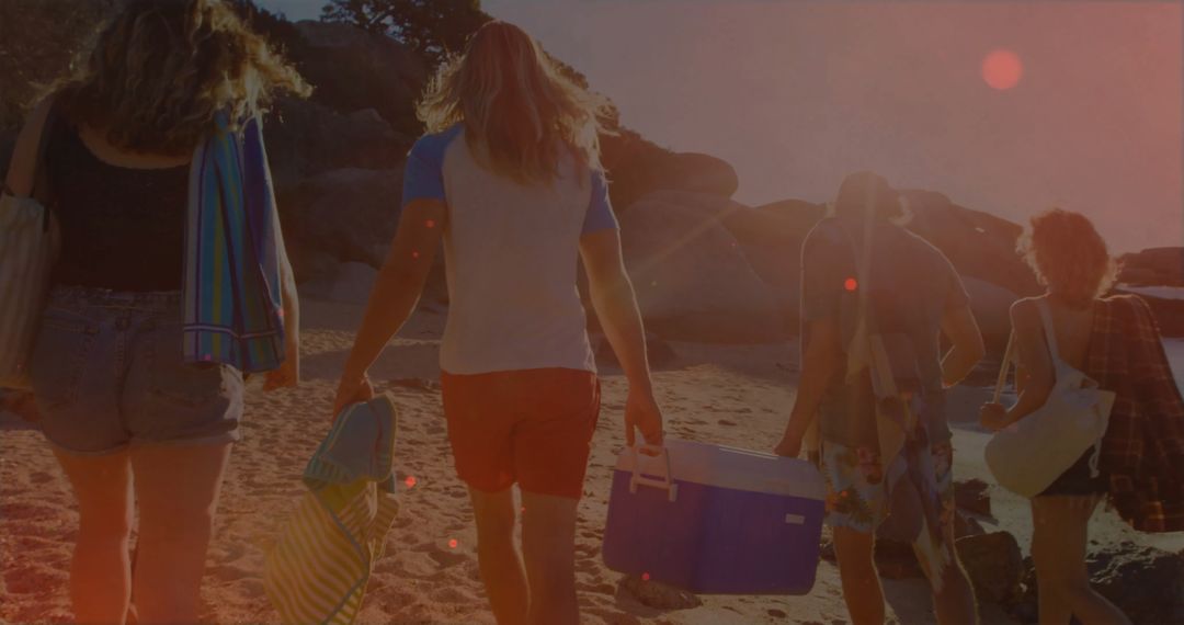Friends Enjoying Beach Day With Towels and Cooler