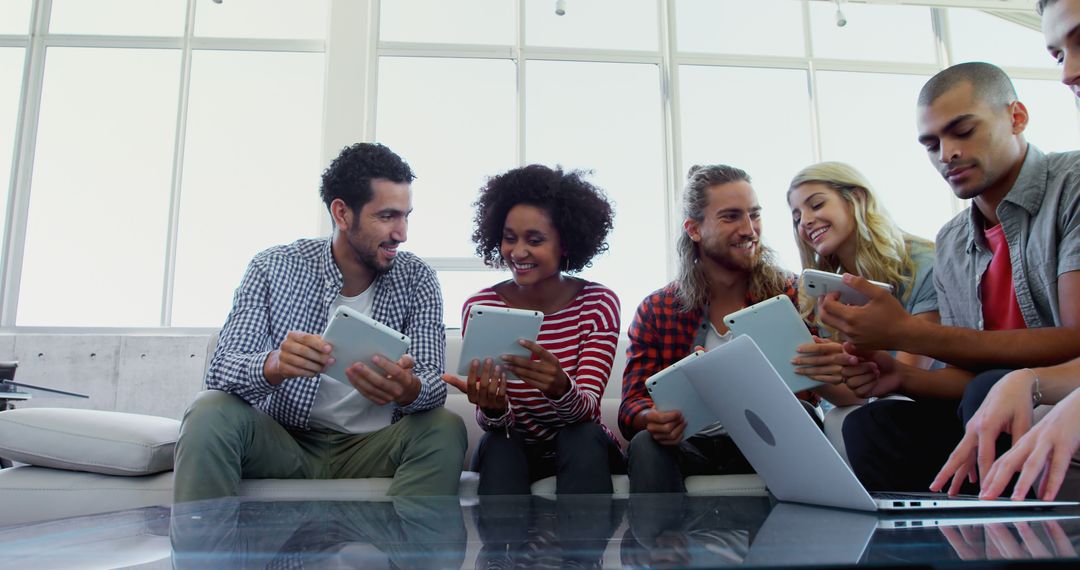 Diverse Team Engaging with Digital Devices in Bright Room