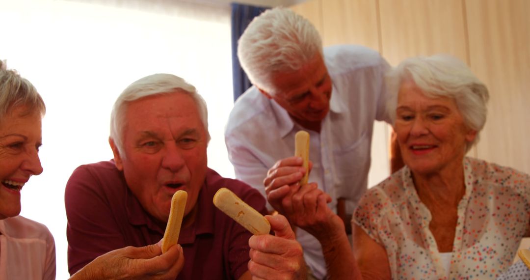 Group of Seniors Enjoying Snacks Together at Home - Free Images, Stock Photos and Pictures on Pikwizard.com