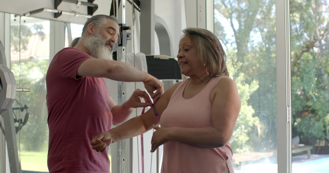 Senior Couple Exercising with Resistance Bands in Gym