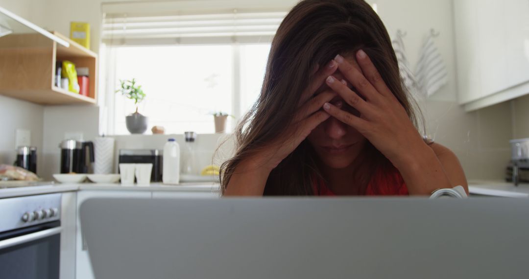 Stressed Woman with Laptop in Kitchen - Free Images, Stock Photos and Pictures on Pikwizard.com