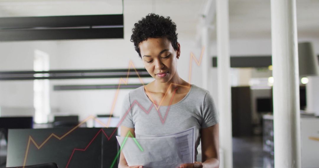 Businesswoman Analyzing Financial Reports with Data Overlay