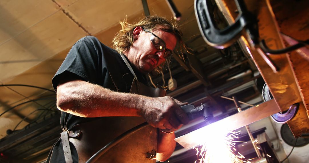 Professional Welder Operating in Industrial Workshop - Free Images, Stock Photos and Pictures on Pikwizard.com