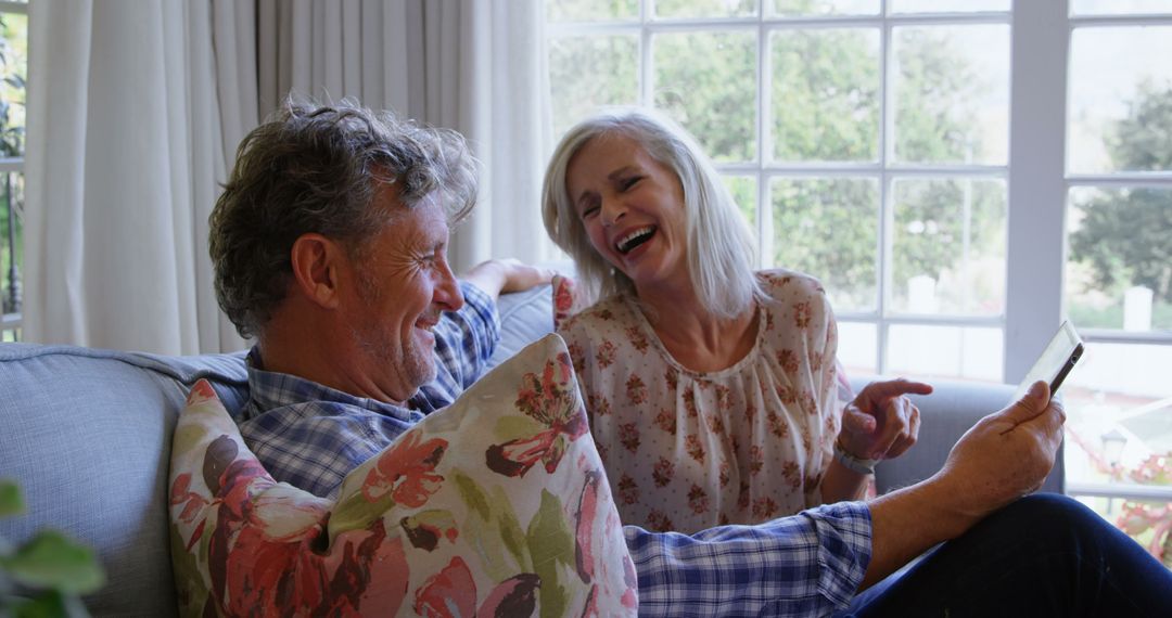 Happy Senior Couple Relaxing Together with Tablet