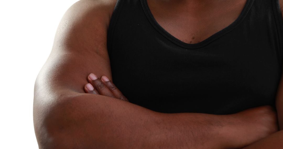 Close-Up of Man Wearing Black Tank Top and Crossing Arms - Free Images, Stock Photos and Pictures on Pikwizard.com