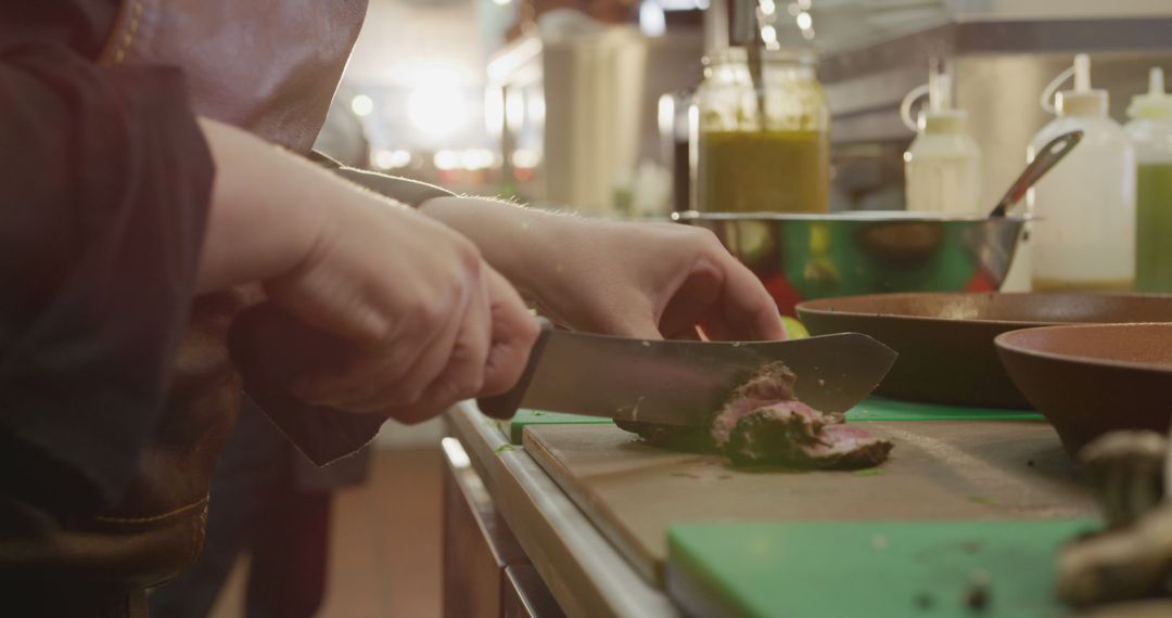 Chef Slicing Meat on Cutting Board in Professional Kitchen - Free Images, Stock Photos and Pictures on Pikwizard.com