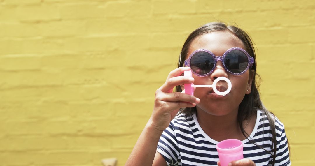 Young Girl Blowing Bubbles in Playful Summer Scene