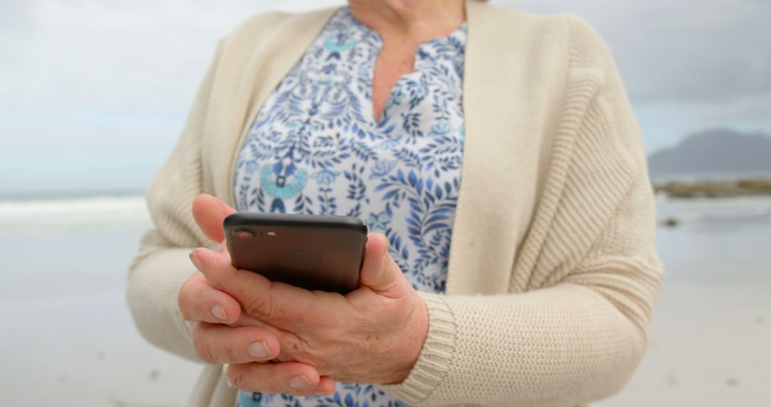 Senior Woman Using Smartphone at Beach - Free Images, Stock Photos and Pictures on Pikwizard.com