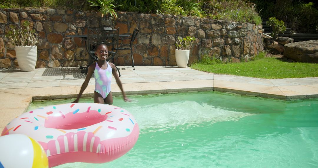 Joyful Child by Poolside with Fun Donut Float on Sunny Day