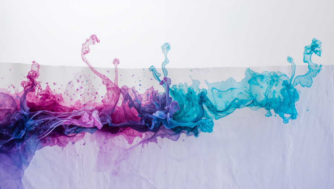 Flowing Magenta to Turquoise Ink Ribbon Creating Fluid Tendrils on Textured Paper