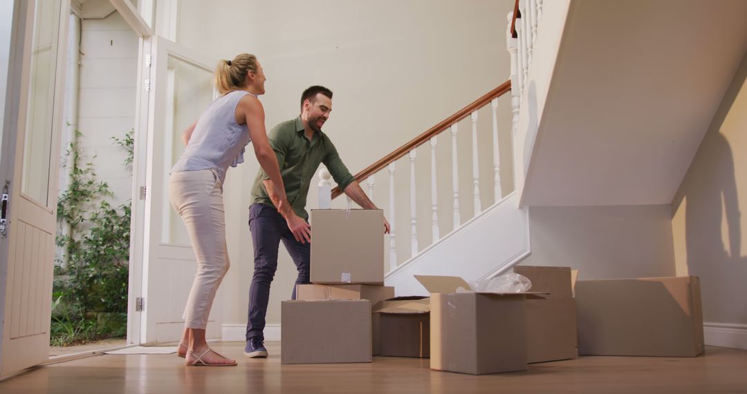 Couple Moving into New Home with Cardboard Boxes