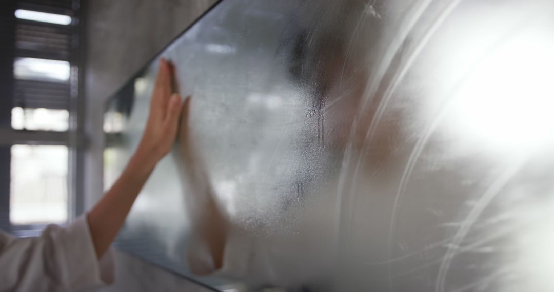 Person Wiping Steam from Bathroom Mirror - Free Images, Stock Photos and Pictures on Pikwizard.com