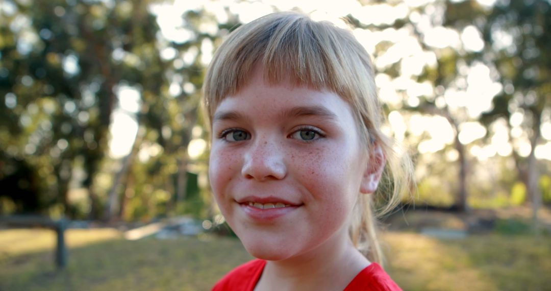 A Caucasian girl with a cheerful expression stands outdoors, with copy space - Free Images, Stock Photos and Pictures on Pikwizard.com