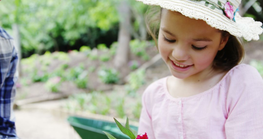 Smiling Girl Enjoying Flowers in Springtime Garden Exploration - Free Images, Stock Photos and Pictures on Pikwizard.com