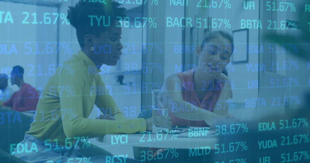 Two women collaborating over documents with stock market data overlay in modern office