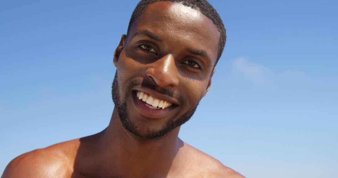 Smiling Shirtless Man Against Clear Blue Sky - Free Images, Stock Photos and Pictures on Pikwizard.com