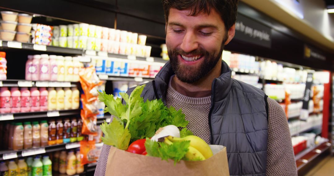 Smiling Man Shopping for Fresh Vegetables in Supermarket - Free Images, Stock Photos and Pictures on Pikwizard.com