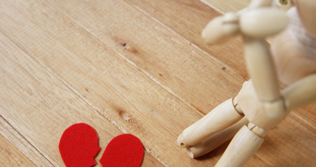 Wooden Figure with Broken Heart Symbolizing Heartbreak