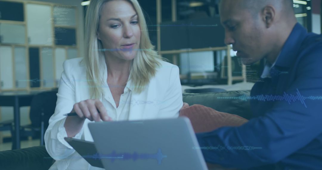 Diverse Business Team Analyzing Digital Solutions in Modern Office