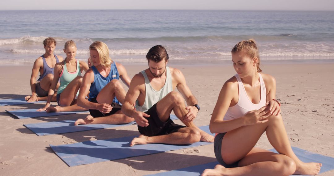 Group Practicing Yoga at Beach during Sunset - Free Images, Stock Photos and Pictures on Pikwizard.com