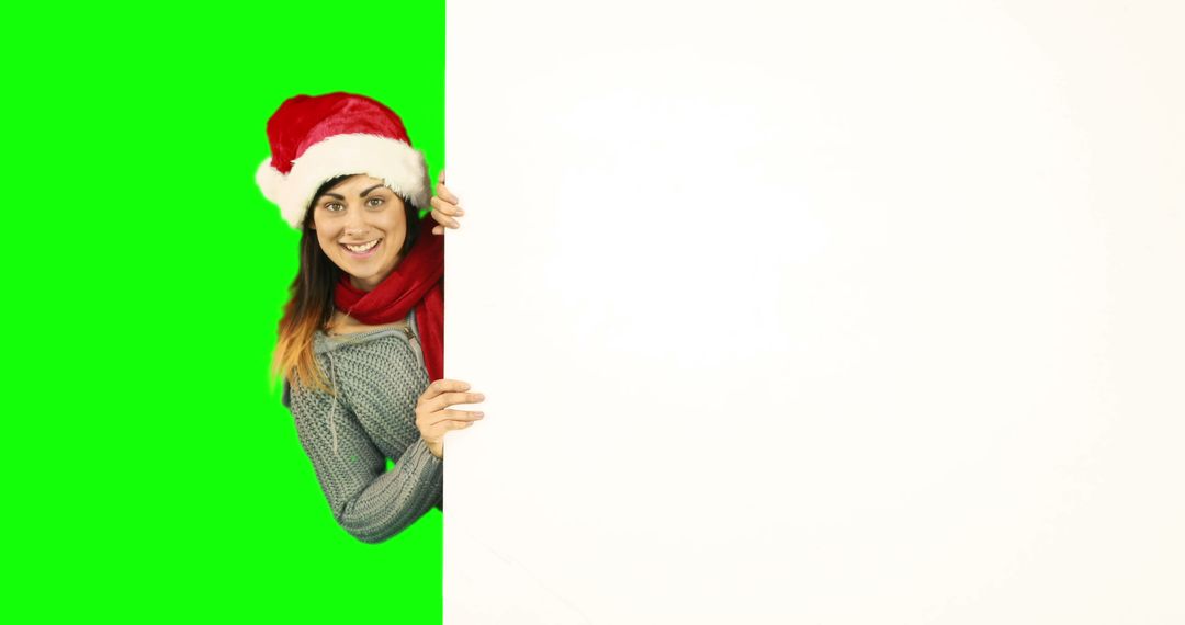 Smiling Woman in Santa Hat Peeking from Blank Space with Green Screen Background - Free Images, Stock Photos and Pictures on Pikwizard.com