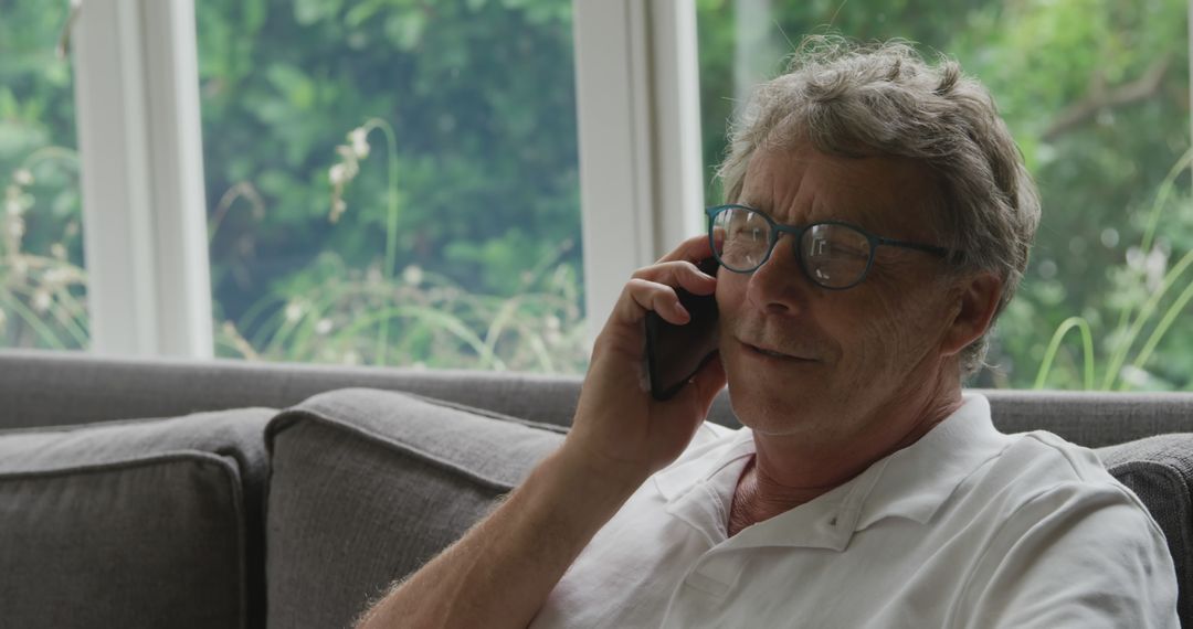 Senior Man Talking on Phone in Relaxed Home Environment