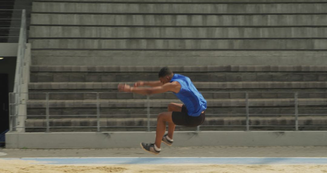 Male Athlete Performing Long Jump - Free Images, Stock Photos and Pictures on Pikwizard.com