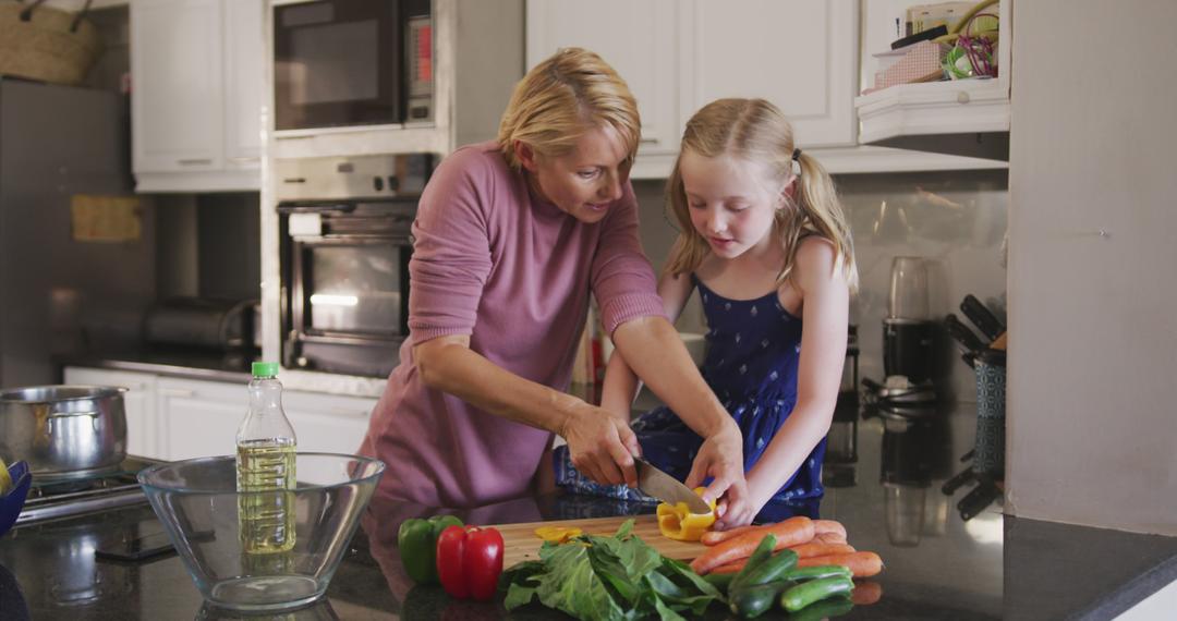 Mother and Daughter Preparing Vegetables in Kitchen Together - Free Images, Stock Photos and Pictures on Pikwizard.com