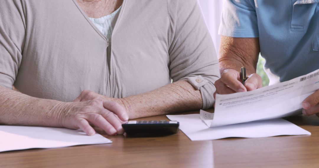 Senior Couple Calculating Expenses at Home