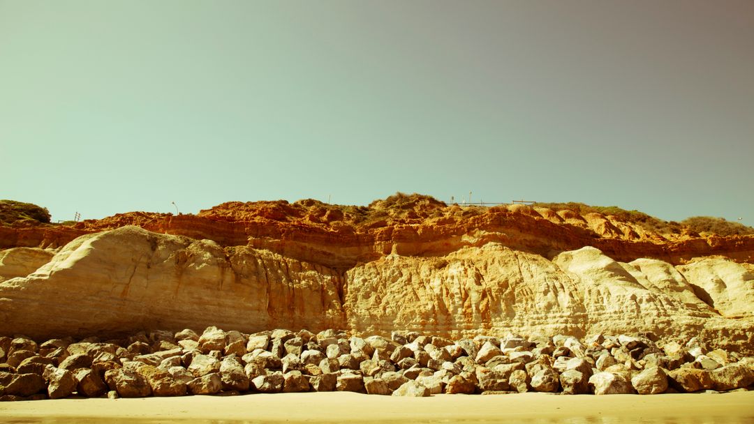 Scenic Coastal Cliff with Rocky Shoreline under Sunny Sky - Free Images, Stock Photos and Pictures on Pikwizard.com