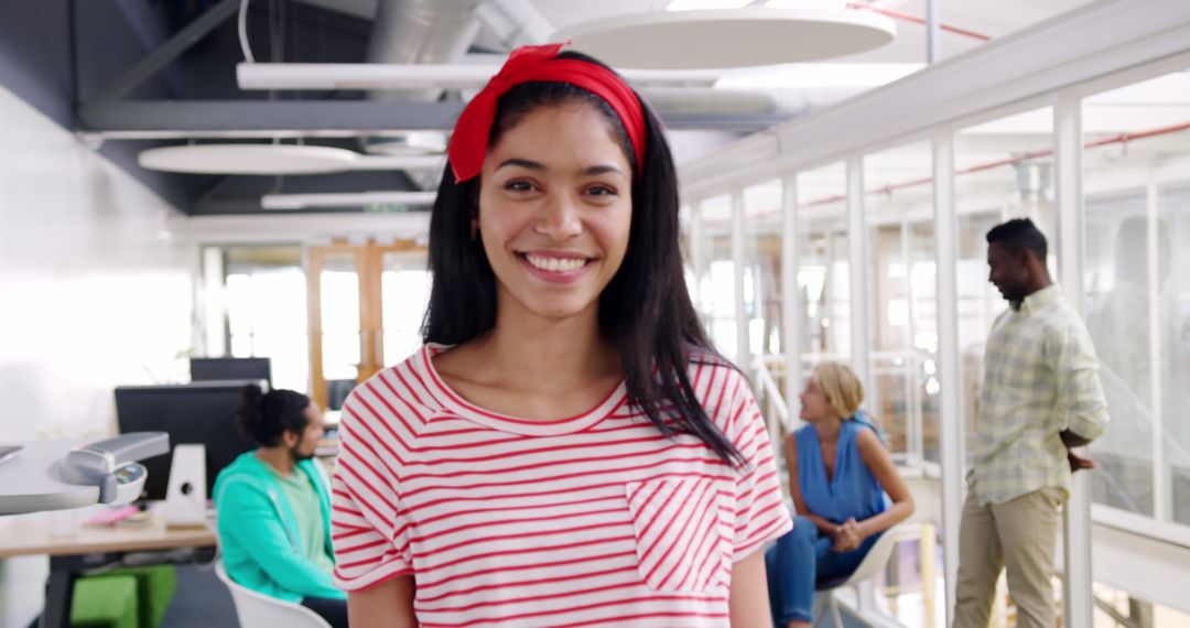 Confident Young Professional Smiling in Creative Office