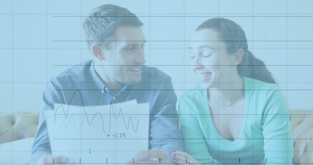 Couple Analyzing Financial Data with Overlaid Graphs