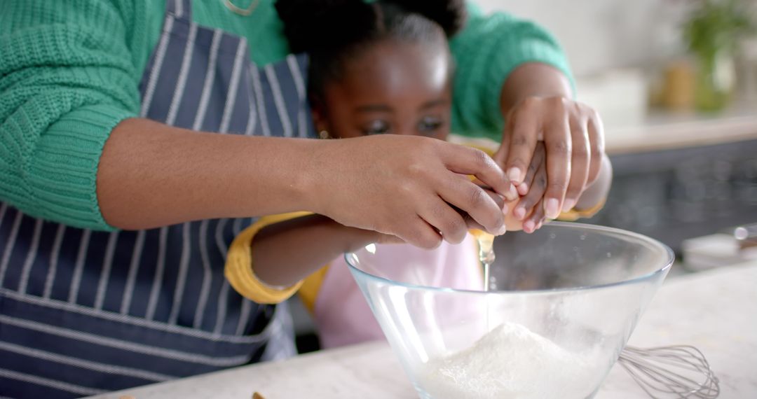 Parent and Child Baking Together in Kitchen, Cracking Egg in Bowl - Free Images, Stock Photos and Pictures on Pikwizard.com