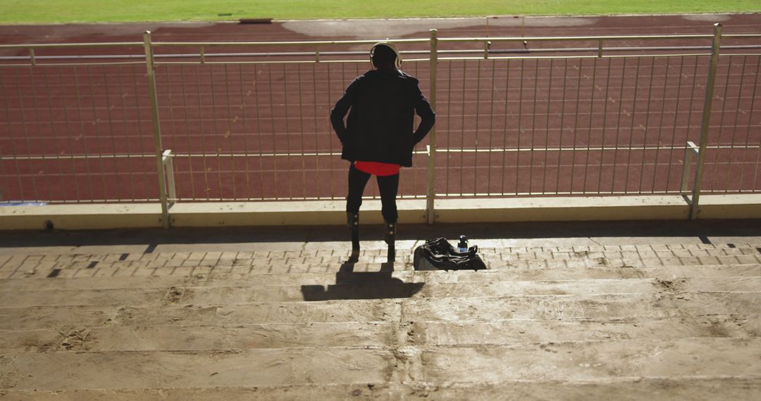 Runner Preparing on Athletic Track Stands in Early Morning - Free Images, Stock Photos and Pictures on Pikwizard.com