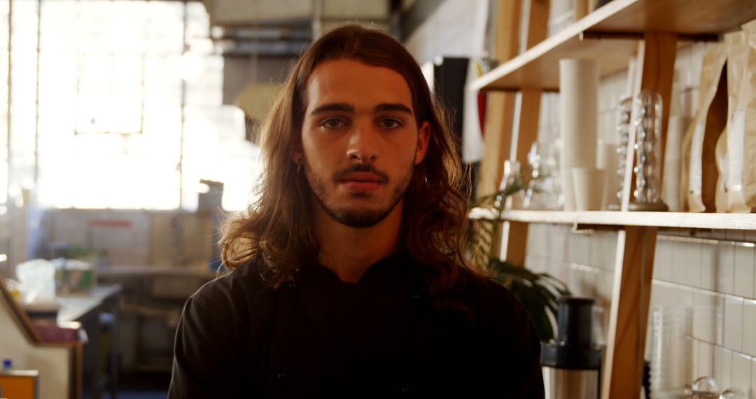 Young Artisan Standing Confidently in Workshop Setting