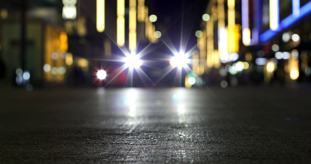 Night city street with car headlights creating bokeh effect